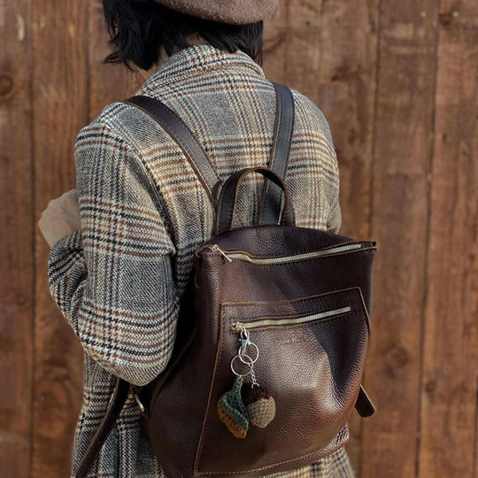 A person facing away from camera carrying a Coldbrew Tote Backpack