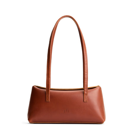 Chestnut | Leather bowler bag with magnetic closure against a white background