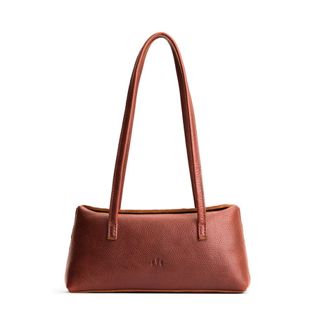 Nutmeg | Leather bowler bag with magnetic closure against a white background