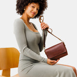 Cognac Mini | Model Wearing Small Leather Crossbody Bag with Magnetic Messenger Bag Closure