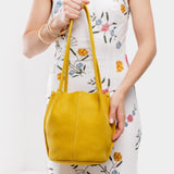 Hello Yellow Classic | Model wearing petite bucket shaped tote bag with matching leather handles
