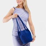 Joni Blue Classic | Model wearing petite bucket shaped tote bag with matching leather handles
