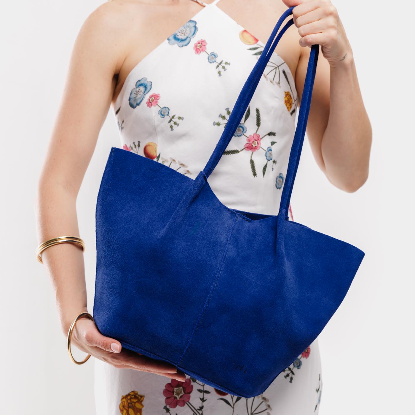 Joni Blue*Large | Model holding wide bucket shaped tote bag with matching leather handles