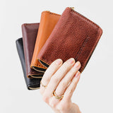 All Variants | Group of Small Zip Wallets being held