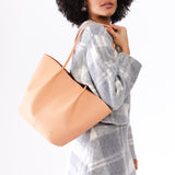 Mamey Large | Model holding wide bucket shaped tote bag with matching leather handles