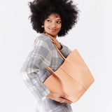 Mamey Large | Model holding wide bucket shaped tote bag with matching leather handles