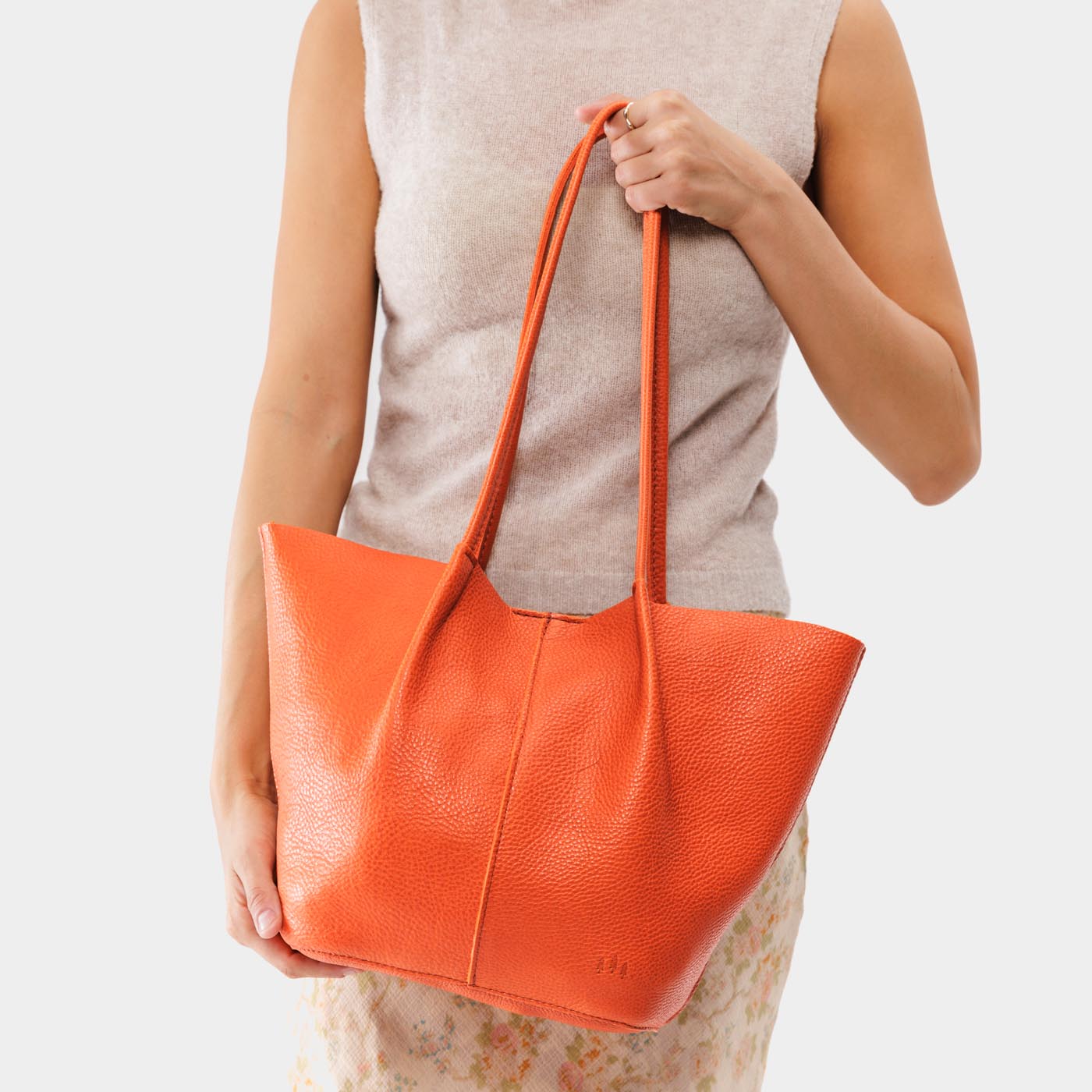 Koi*Large | Model holding wide bucket shaped tote bag with matching leather handles