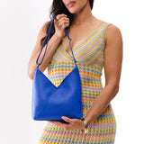 Astro Blue Small | Model wearing petite shoulder bag with adjustable strap and magnetic snap closure