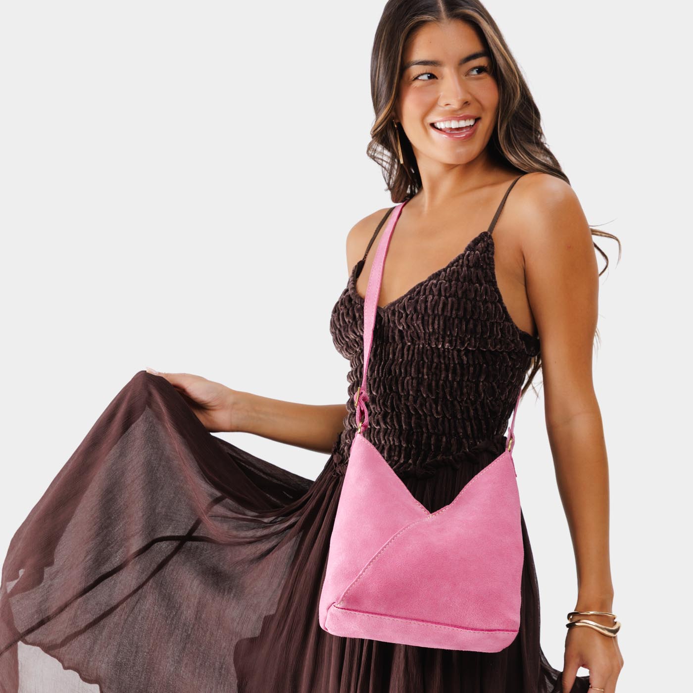 Pink Suede*Small | Model wearing petite shoulder bag with adjustable strap and magnetic snap closure