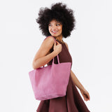 Pink Suede Oversized | Model holding extra wide bucket shaped tote bag with matching leather handles