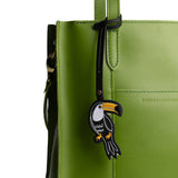 Toucan | Toucan embroidered on a black leather tassel on a green bag