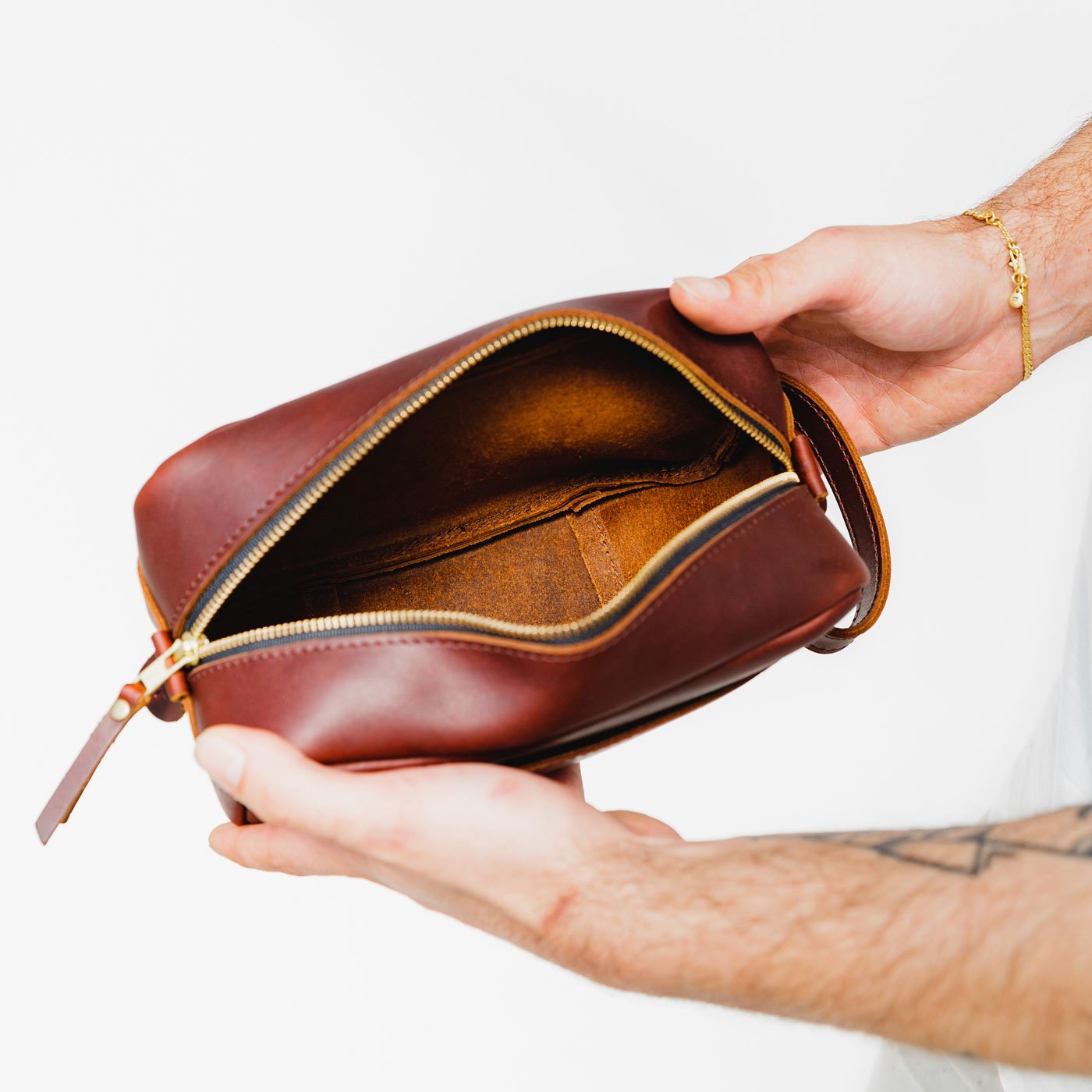 All Color: Cognac | Model holding large rectangular leather dopp kit