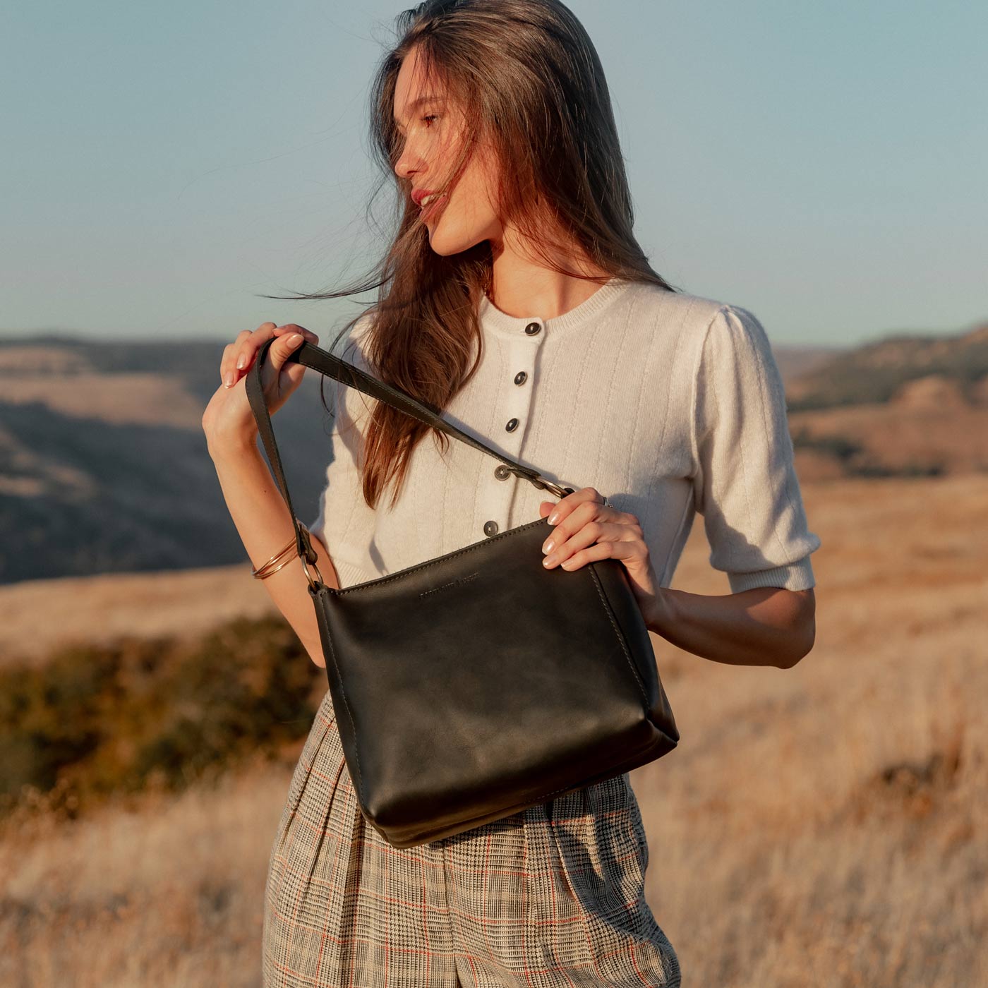 Black | Triangular shoulder bag with antiqued brass finished hardware