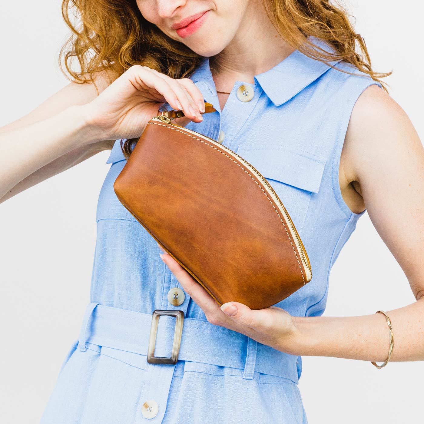 All Color: Honey | Spacious leather makeup bag with curved seams and top zipper