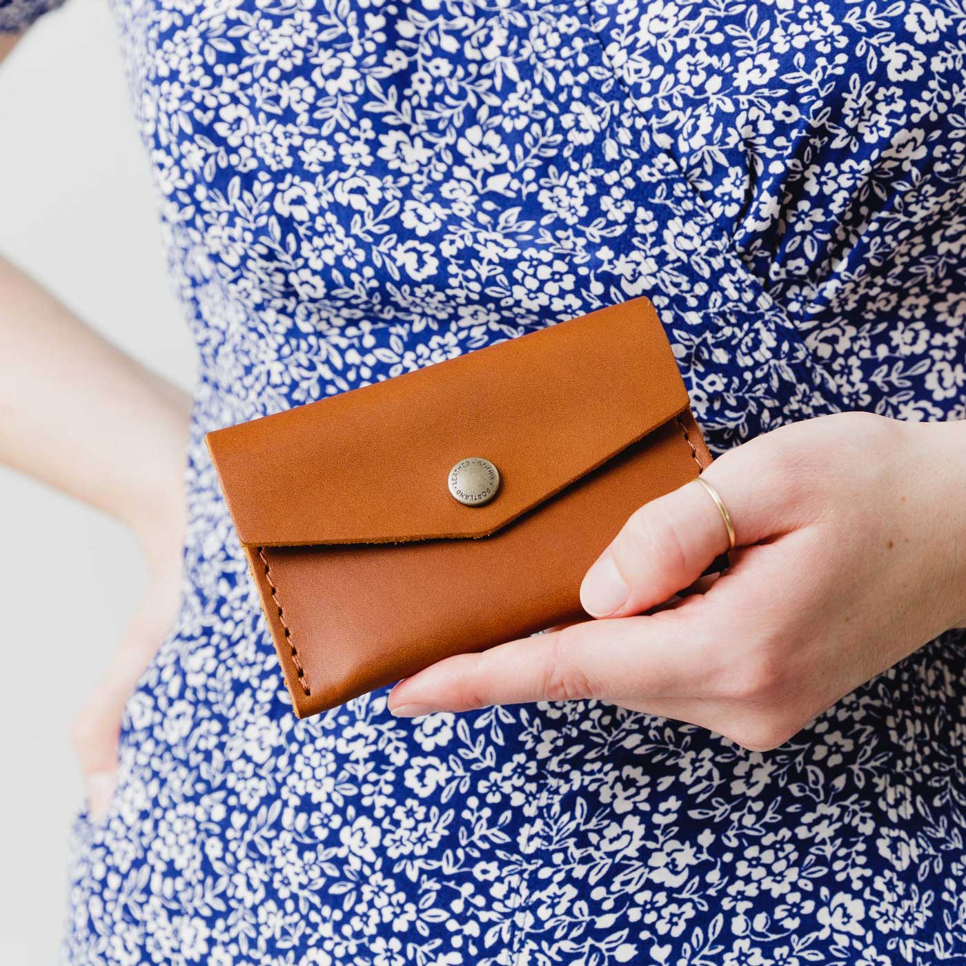 Honey | Model holding small leather envelope wallet with snap closure